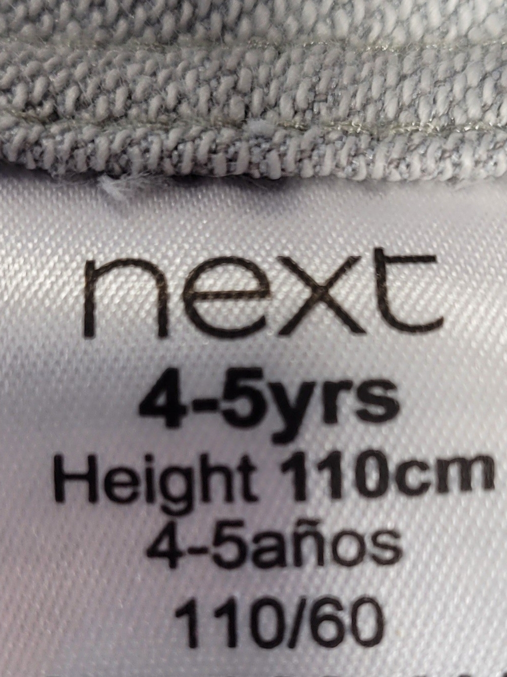 next White and Light Gray Kids' Garment Tag Close-Up - Picture 3 of 5